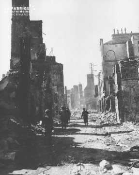 Soldats progressant parmi les ruines de Mortain